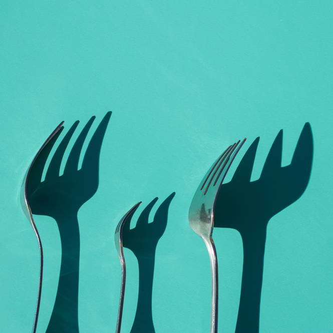 Forks in front of blue wall