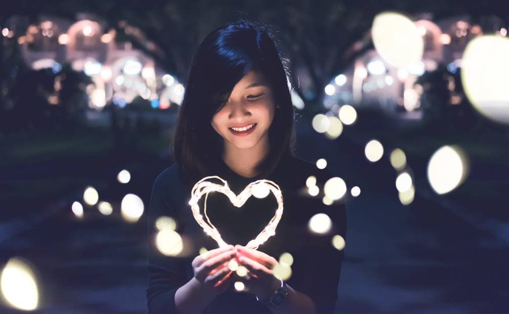 Woman holding a heart shaped garland