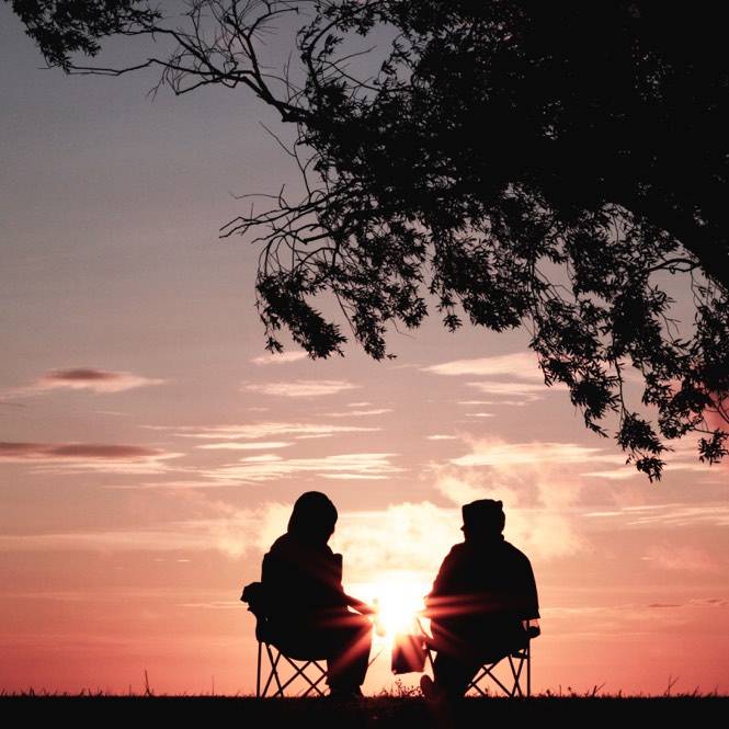 two people talking while watching the horizon
