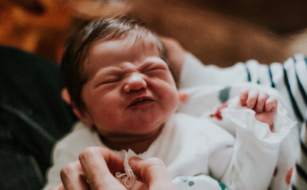 Infant in the arms of his mother